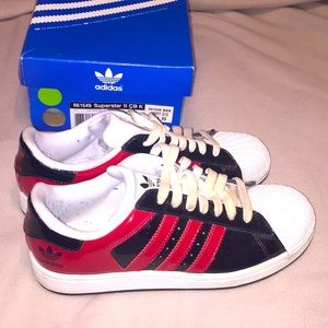 Adidas Superstar II black patent sneakers.